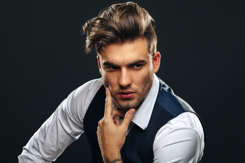 Man with a styled haircut and beard in a barber shop